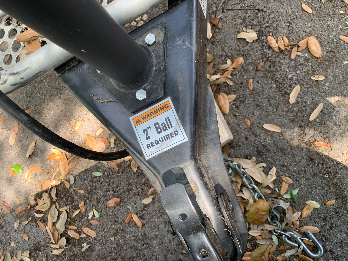 Essential RV rental component: a trailer hitch coupler showing a "2" Ball REQUIRED" warning for safe towing.
