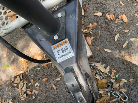 Essential RV rental component: a trailer hitch coupler showing a "2" Ball REQUIRED" warning for safe towing.