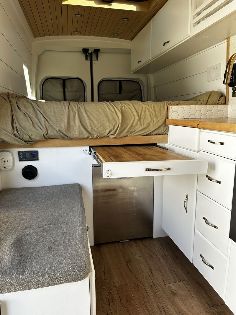  ideal for compact travel.|Bright RV rental van conversion interior reveals compact kitchen with hexagonal tiles — photo 6