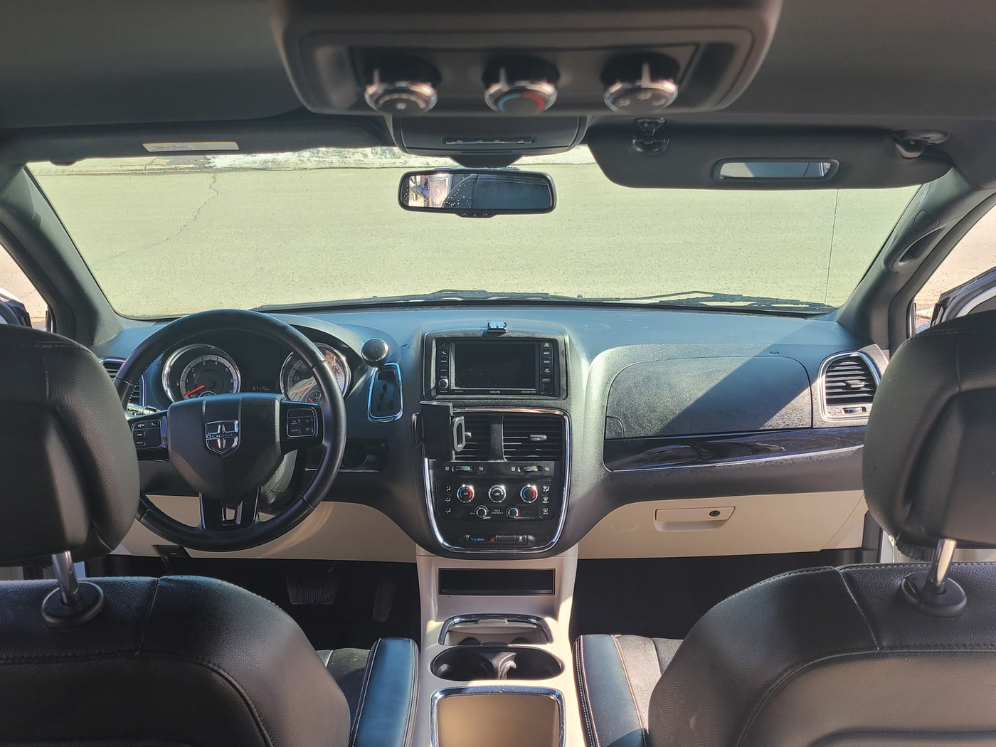 Interior view of a spacious vehicle, ideal for an RV rental adventure, featuring dashboard, steering wheel, and front cabin. — photo 6