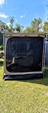 RV rental: a spacious screen room annex pitched on green grass under a clear blue sky.
