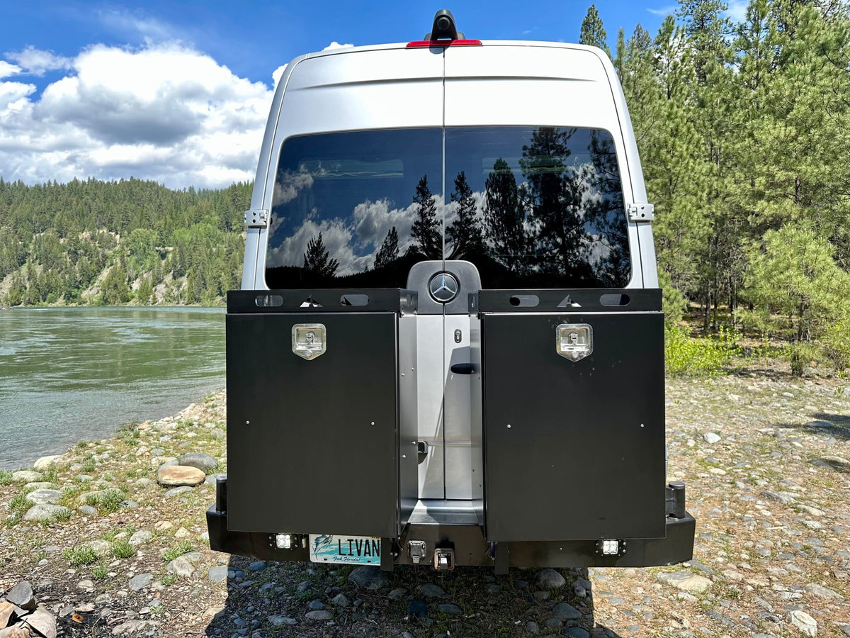  fire pit ready for camping.|Back of an RV rental: a silver Mercedes Sprinter camper van with black storage boxes — photo 5
