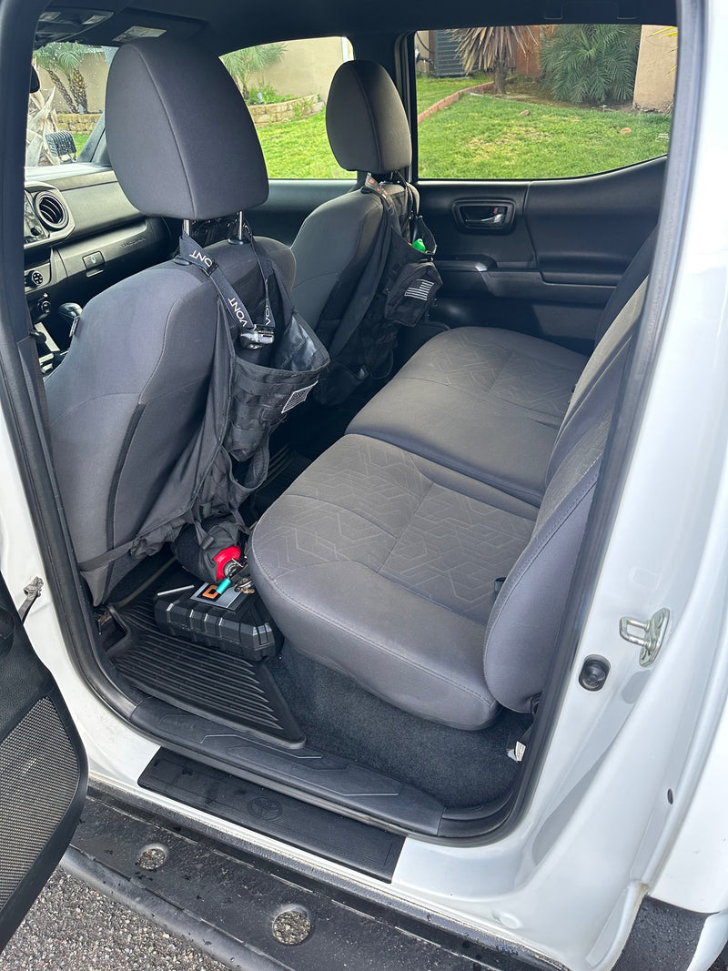 Truck rear interior: folded seats reveal storage for bags, a case, and extinguisher. Ready for an RV rental adventure. — photo 11