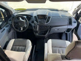 RV rental: Clean, spacious front cabin with a Ford dashboard, steering wheel, and comfortable two-tone seats.