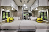 Spacious, modern RV interior showing two beds with sleeping bags and pillows, ready for your next rv rental adventure.