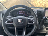Inside an RV rental, showing the driver's perspective: steering wheel, digital dashboard with Apple CarPlay, and navigation.