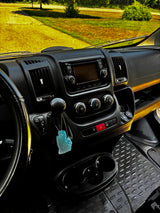 RV rental dashboard interior: media screen, climate controls, gear shifter (with TOW HAUL), cupholders, and air freshener.