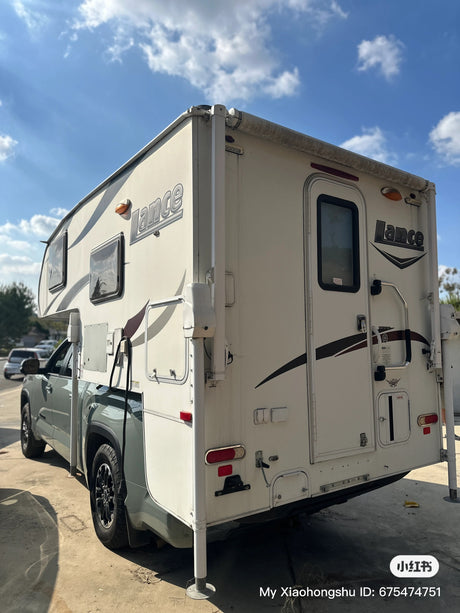 Explore with this Lance truck camper on a grey pickup, perfect for your next RV rental adventure. Compact and versatile.