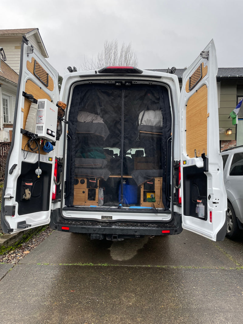 Rear view of an RV rental camper van conversion. Open doors reveal a mosquito net, comfy beds, storage, and an external water heater. — photo 13