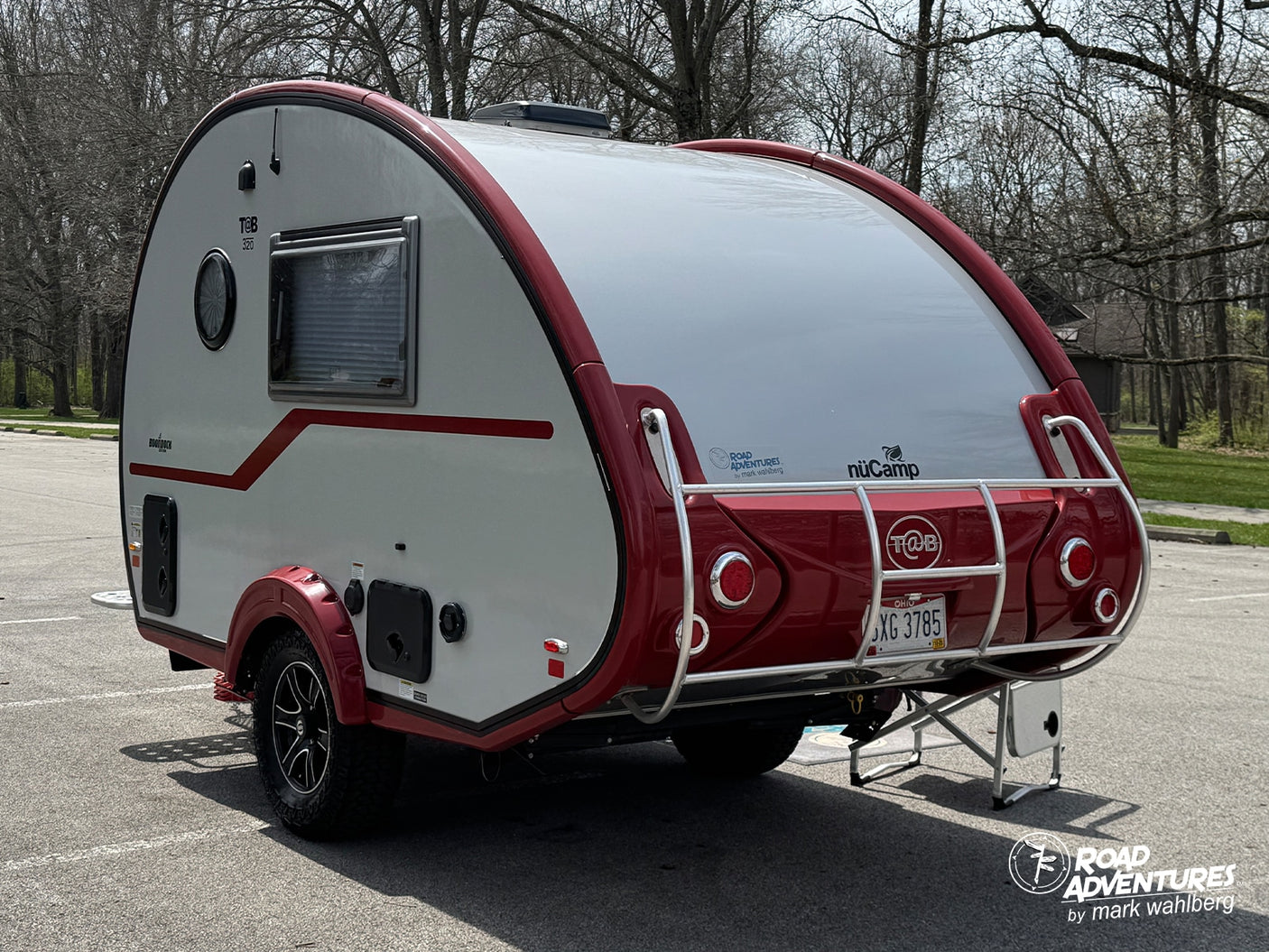 This T@B 320 teardrop RV rental, a white nuCamp camper with red trim, is ready for your next road adventure and camping trip.