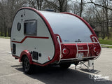 This T@B 320 teardrop RV rental, a white nuCamp camper with red trim, is ready for your next road adventure and camping trip.