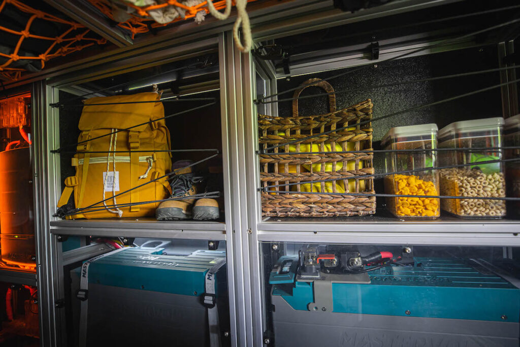 RV rental interior: organized gear, food, & power systems ready for adventure.