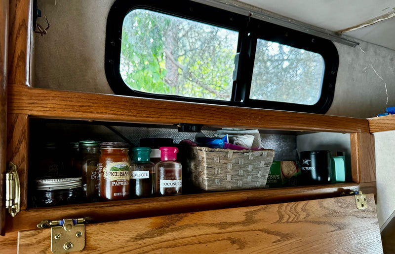 and a double sink. Safety warnings are visible.|Cozy RV rental interior with comfortable patterned seats — photo 9