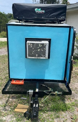  ideal for an rv rental.|Light blue trailer with black trim and a black Ironman rooftop tent