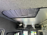 RV rental interior with insulated roof vent cover, gray ceiling, and practical overhead storage.