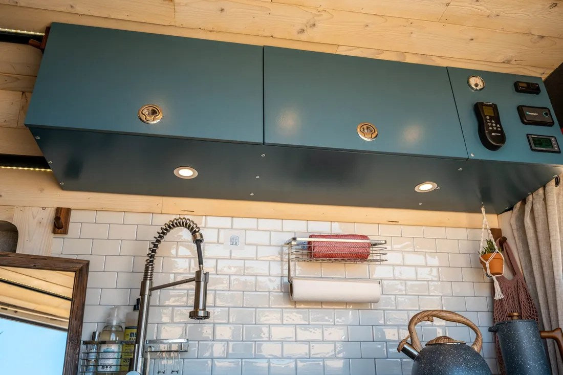  and cozy bed in a compact camper van.|Scenic rv rental setup: a white camper van with an open door — photo 10