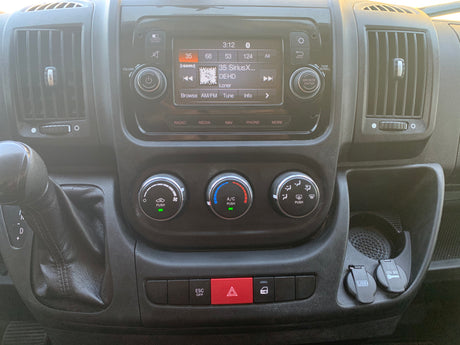 RV rental dashboard: central infotainment, climate, gear shifter, hazard lights, USB, and 12V outlets.