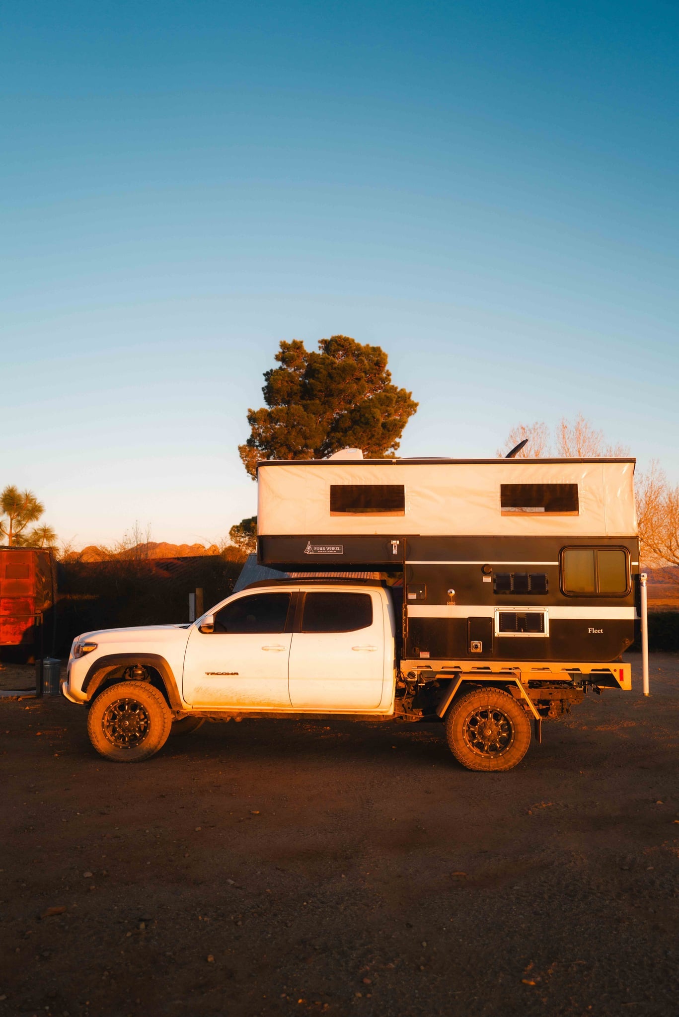  plus a functional kitchenette. Ideal for camper travel!|A white Toyota Tacoma with an overland pop-up RV camper — photo 10