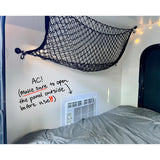 RV rental interior: cozy bed, overhead storage net, and an AC unit. Remember to open its outside panel before use!