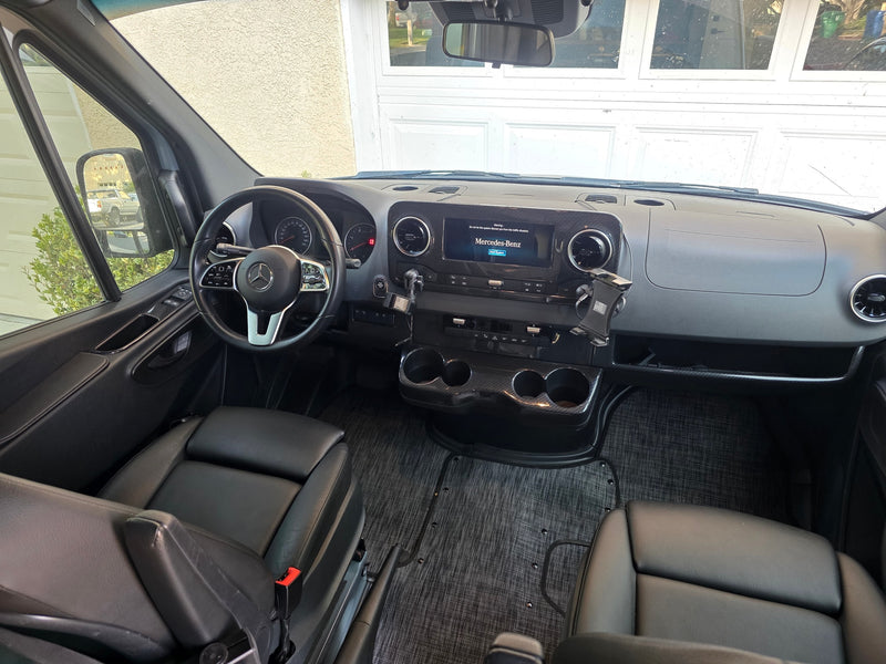 Spacious Mercedes-Benz RV rental interior: modern dashboard, steering wheel, infotainment screen, and black leather seats. — photo 5