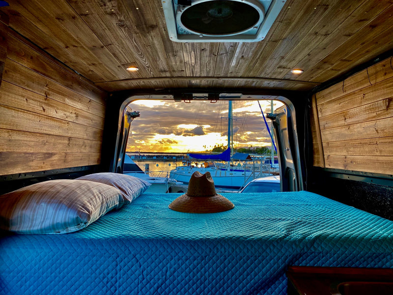 Experience sunset tranquility from this comfortable RV rental camper van bed — photo 1