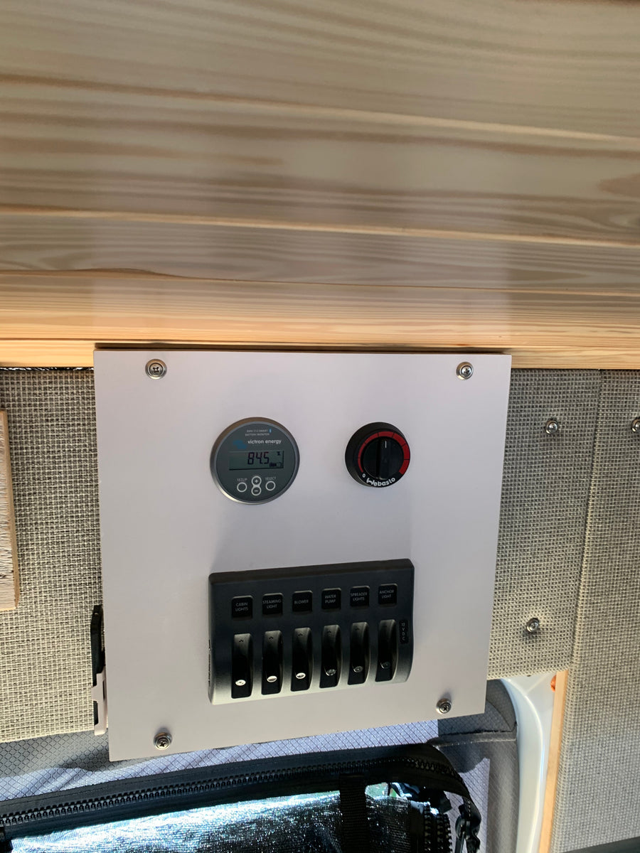 RV rental control panel: Victron battery monitor (84.5%), Webasto heater, and switches for lights, water pump, blower.
