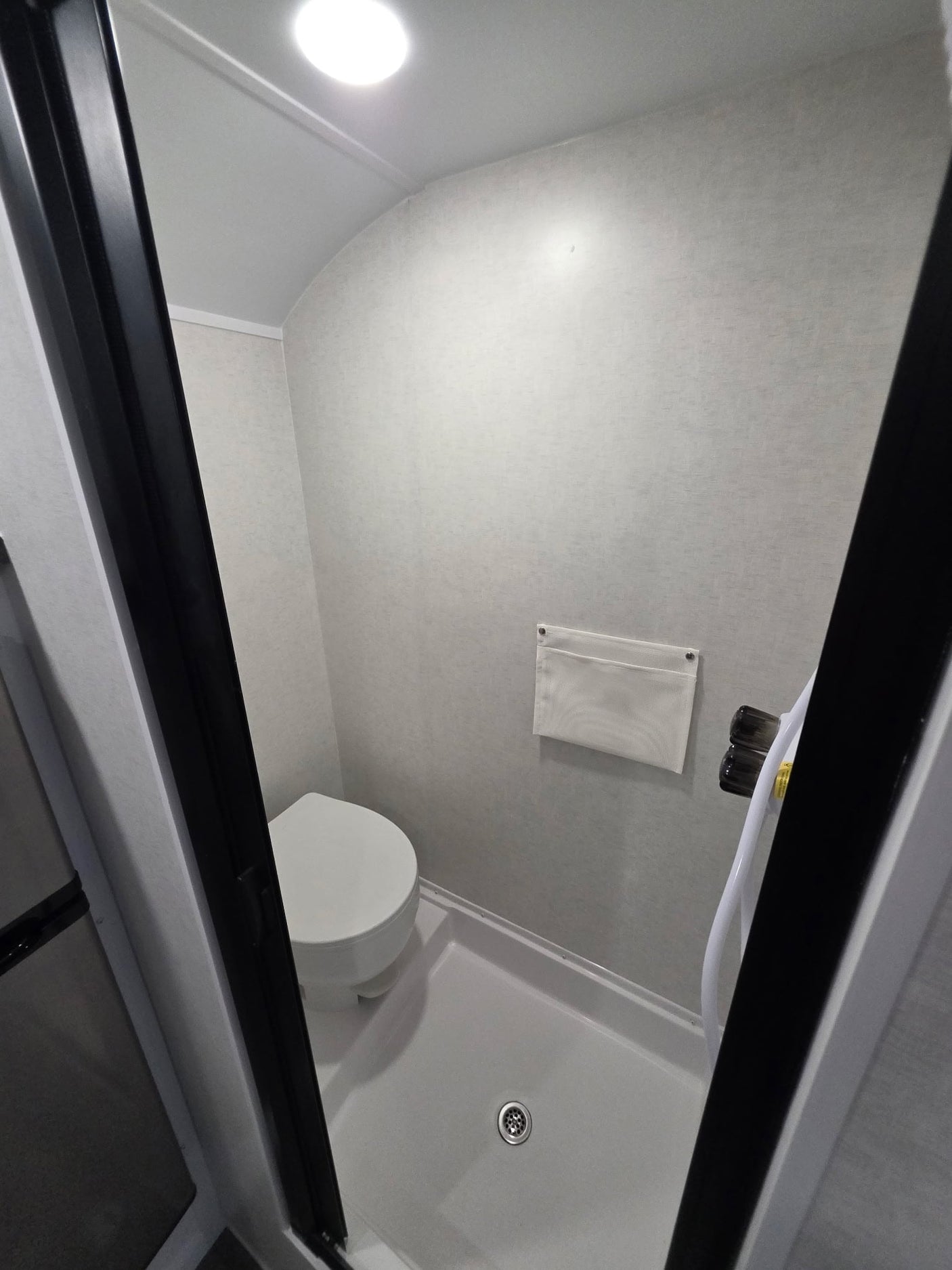  great for an rv rental.|Black toy hauler rv rental shows its rear ramp extended and screen door