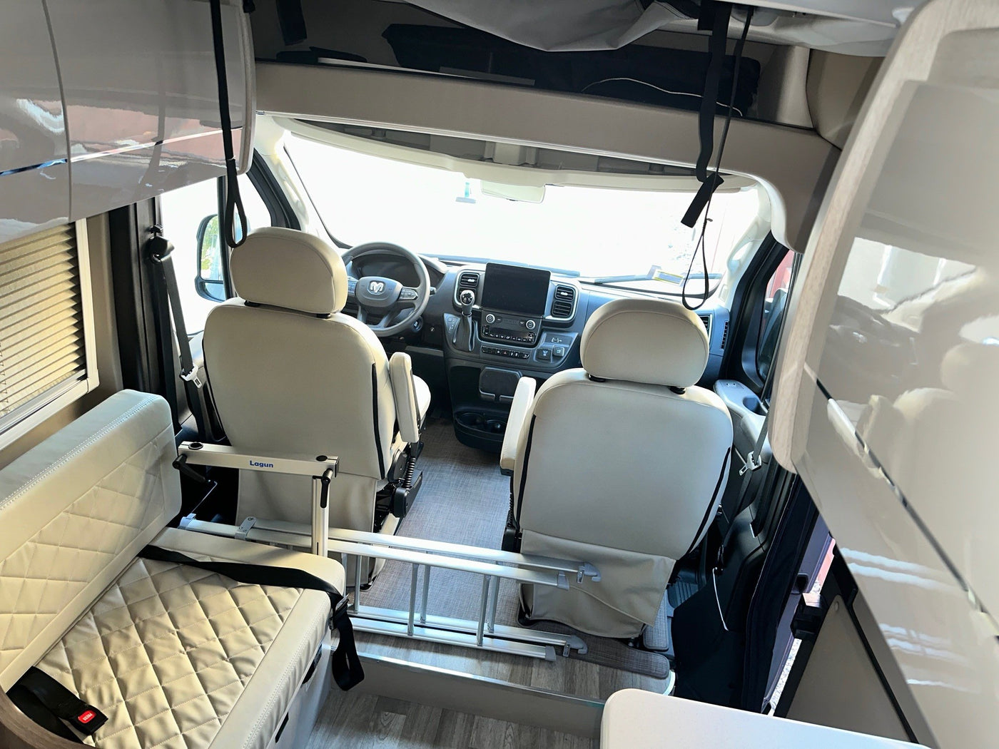  and rear windows.|Compact rv rental interior with a kitchenette — photo 6
