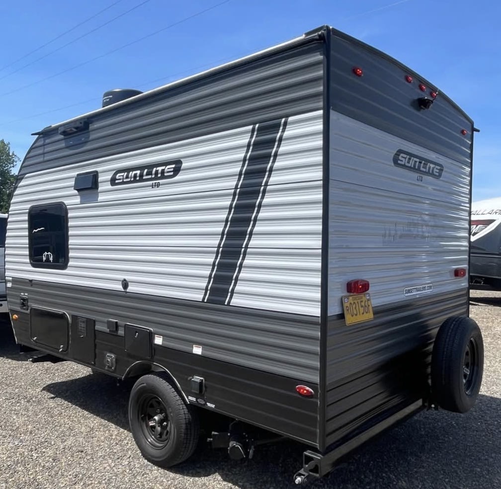  ideal for an RV rental. Features a rear spare tire and side awning.|A compact