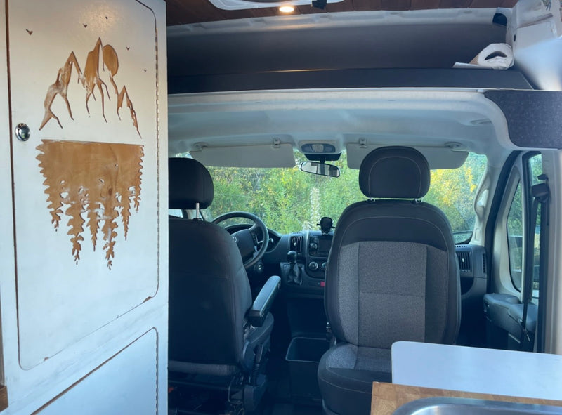  and practical storage. Perfect for adventurers!|Comfortable custom RV rental interior with a bed — photo 9
