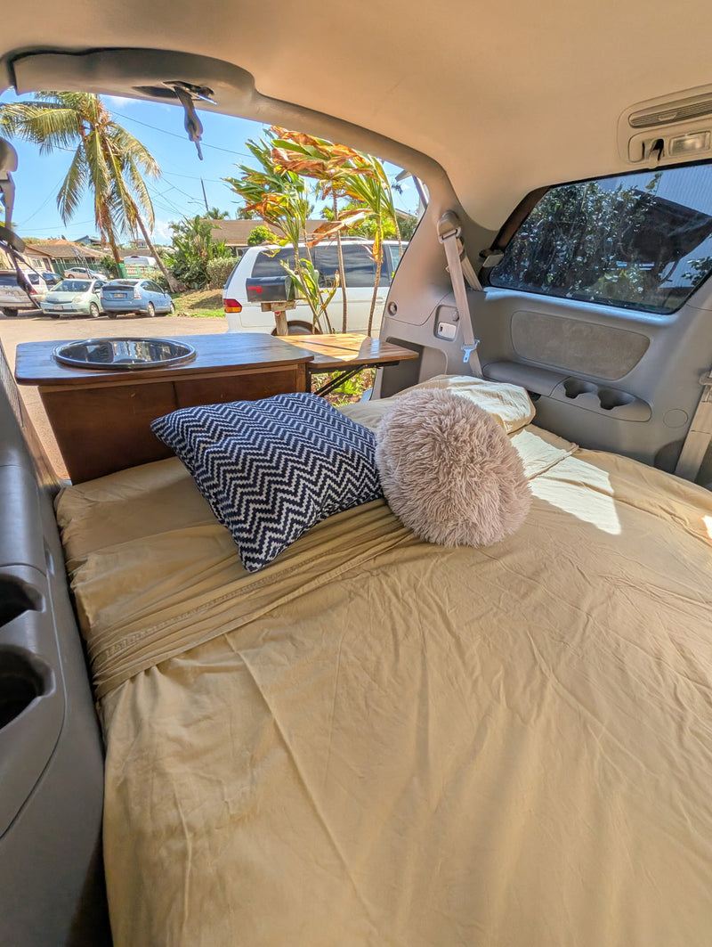  consider an RV rental for bigger adventures.|Minivan RV rental interior: a comfy bed with pillows — photo 2