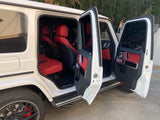 Experience luxury beyond an **rv rental**! This white G-Wagen SUV showcases a striking red leather interior with all doors open.