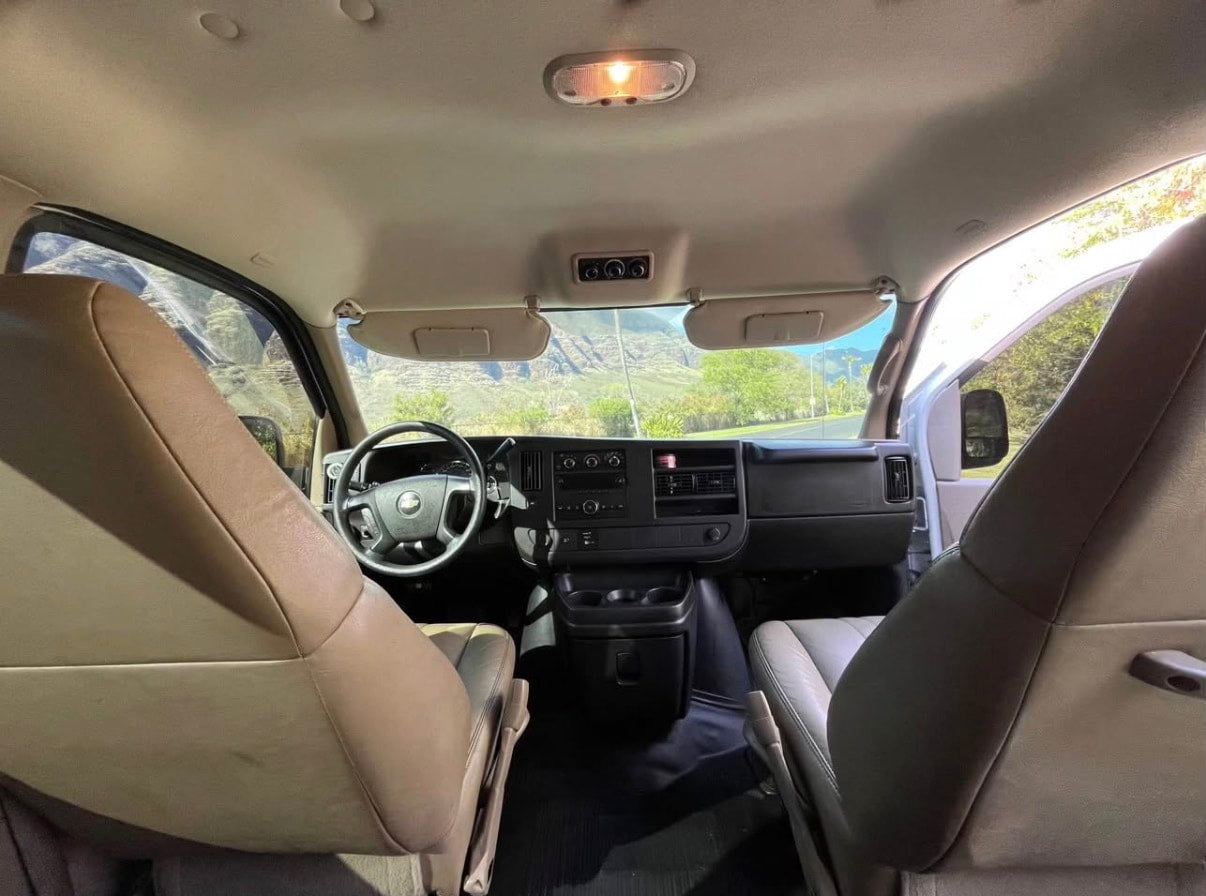 Inside your rv rental van: driver's view, dashboard, and front seats with a scenic road ahead. — photo 7
