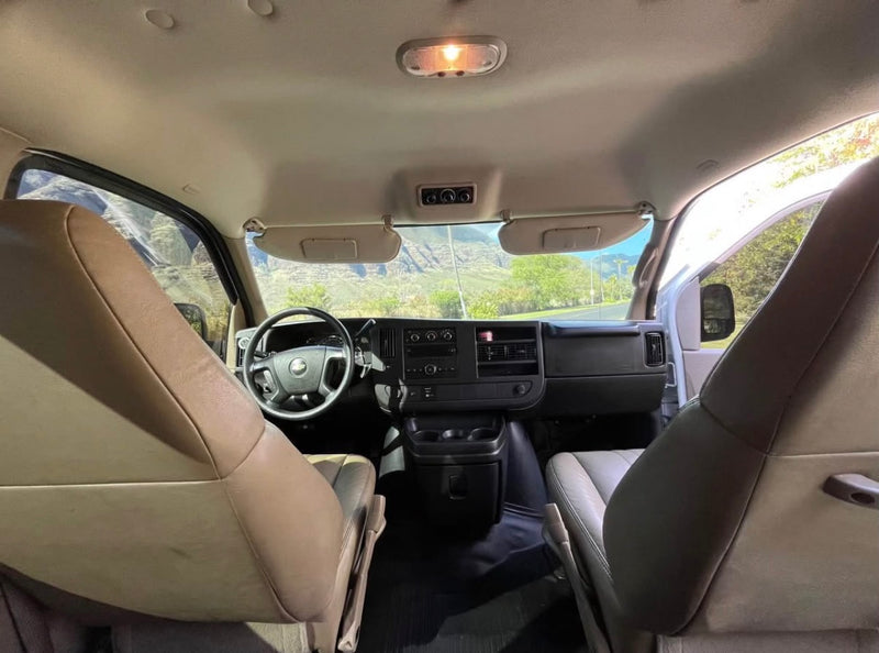 Inside your rv rental van: driver's view, dashboard, and front seats with a scenic road ahead. — photo 7