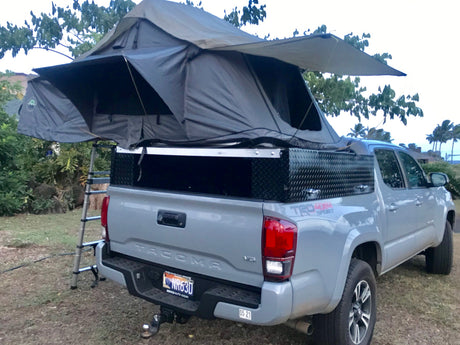 This Toyota Tacoma pickup, outfitted with a rooftop tent, makes for a great RV rental for overlanding adventures in Hawaii.