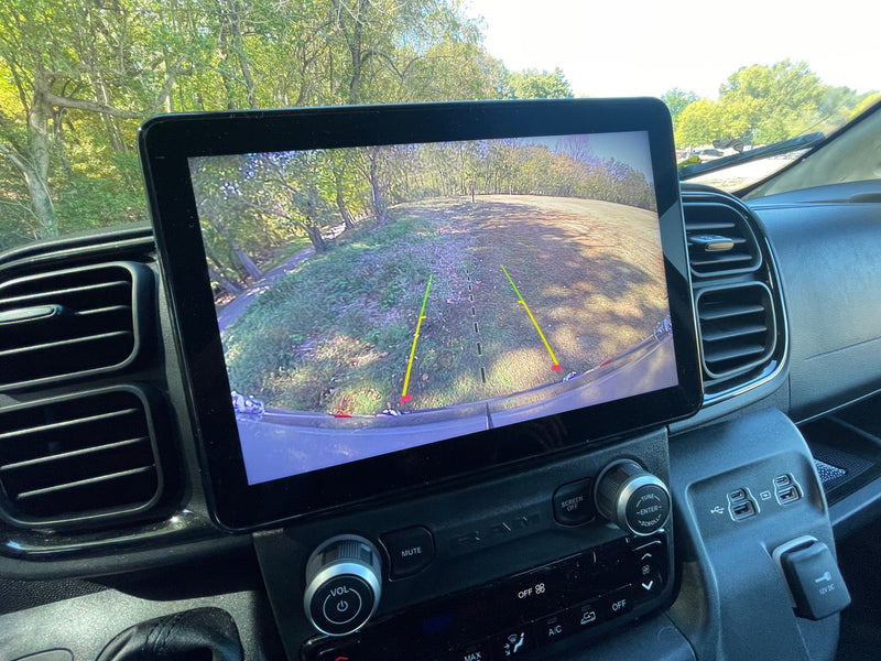 Inside an rv rental: dashboard screen displays backup camera view. Physical controls for audio, climate, & multiple USB ports are visible. — photo 17