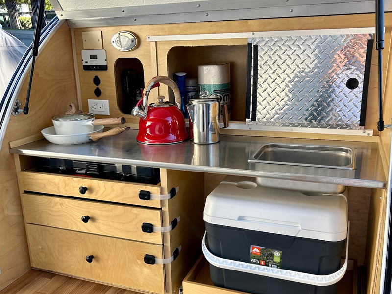 ready for rest.|RV rental camping kitchen: a Coleman stove and red lighter stored in a wooden pull-out drawer — photo 6