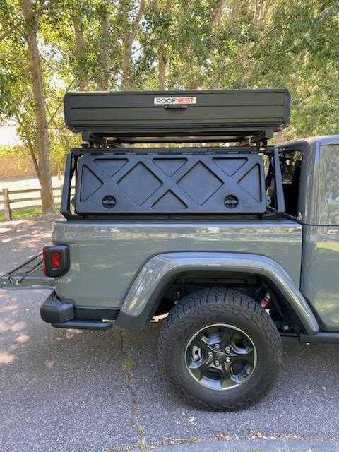  featuring a roof-top tent & fuel cans for your adventure camping!|Gray Jeep Gladiator with Roofnest rooftop tent and bed rack — photo 2