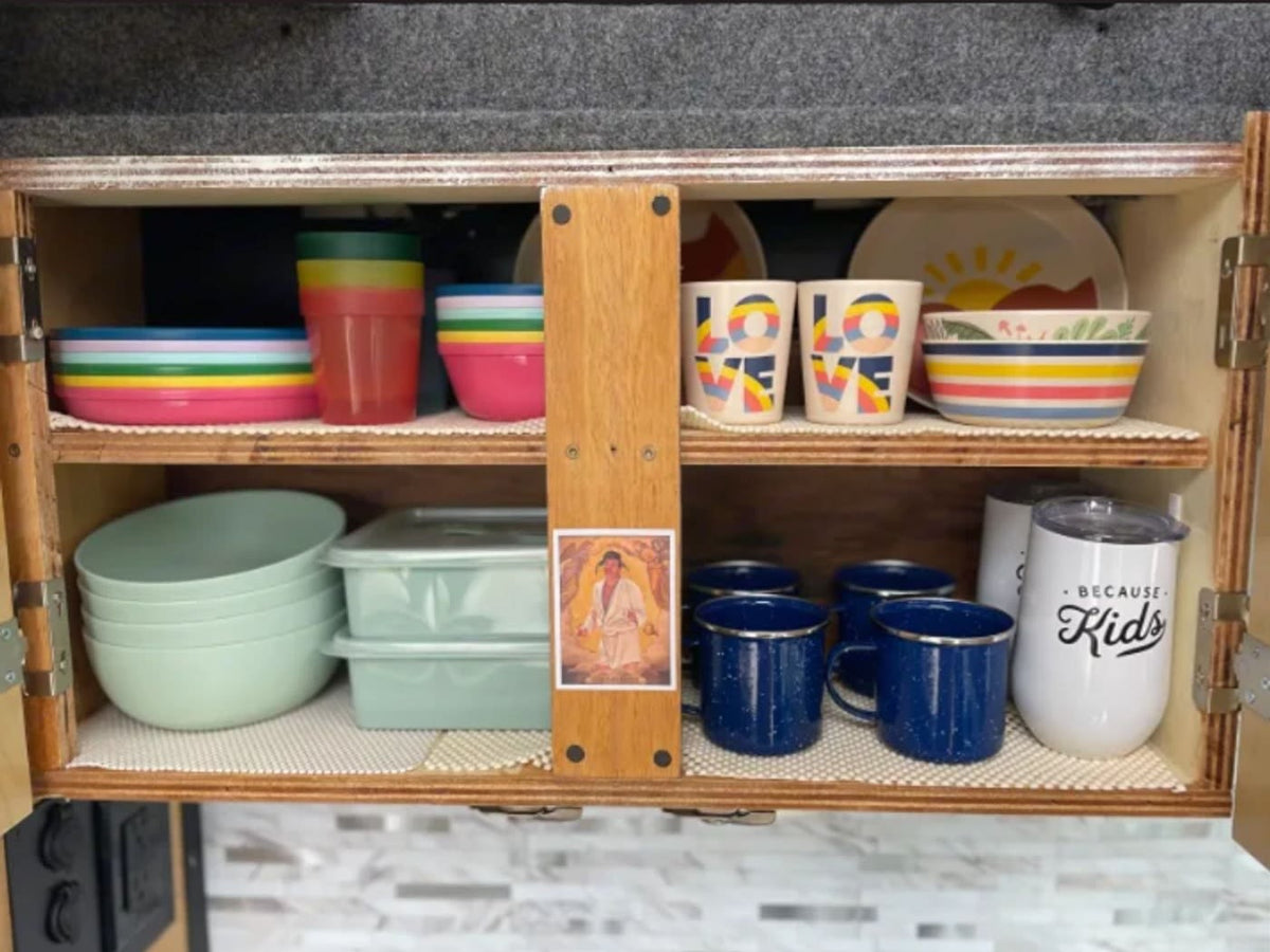  and stylish tile walls for comfortable travels.|Functional RV rental interior: compact kitchen counter with fresh fruit — photo 4