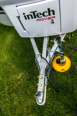 Close-up of an inTech ROVER travel trailer's hitch and jack, set on grass, perfect for RV rental camping.
