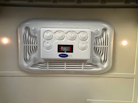 Stay cool in your RV rental with this Mabru AC unit, featuring digital controls, adjustable vents, and integrated lighting.