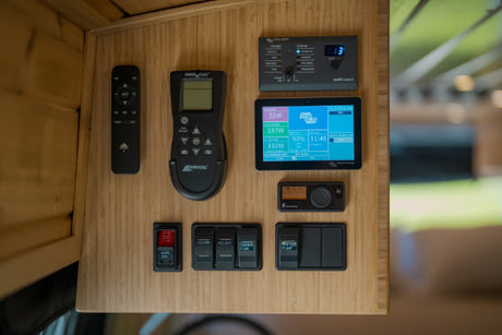 RV rental interior control panel: MaxxAir fan, Victron power monitoring, and switches for lights & water pump.