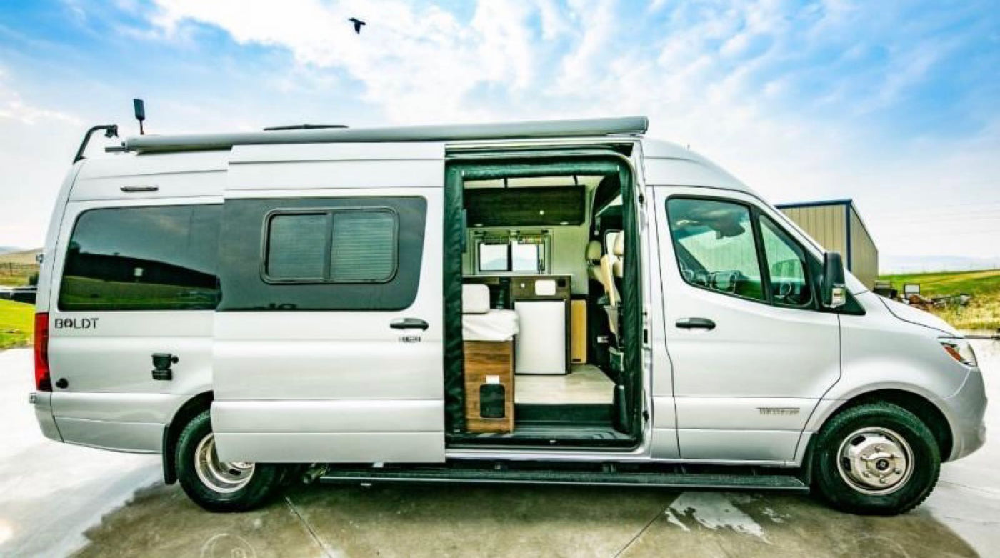  and comfortable swiveling front seats for travel.|Inside an RV rental: a well-equipped kitchen with microwave — photo 9