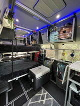 RV rental interior with bunk beds, integrated storage, and cooler. An organized, compact space for your next adventure.