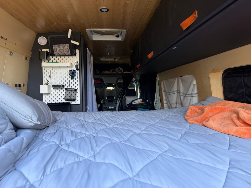  and integrated fridge.|Wood-paneled rv rental interior with a kitchenette — photo 11