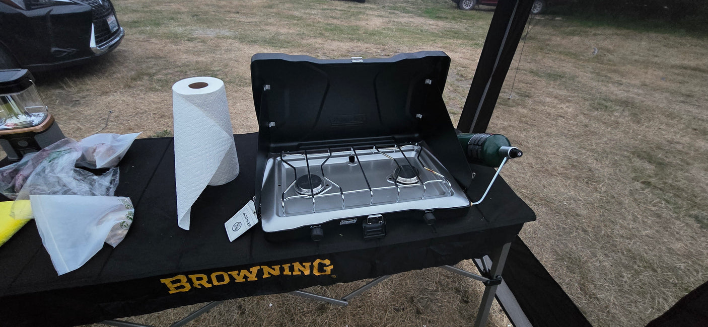 Camping essentials: Coleman stove, propane, and Browning table. Great for an rv rental outdoor kitchen setup.
