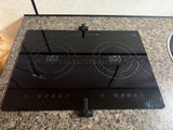 This rv rental kitchen features a modern black "MINI DUO" two-burner induction cooktop with digital touch controls.