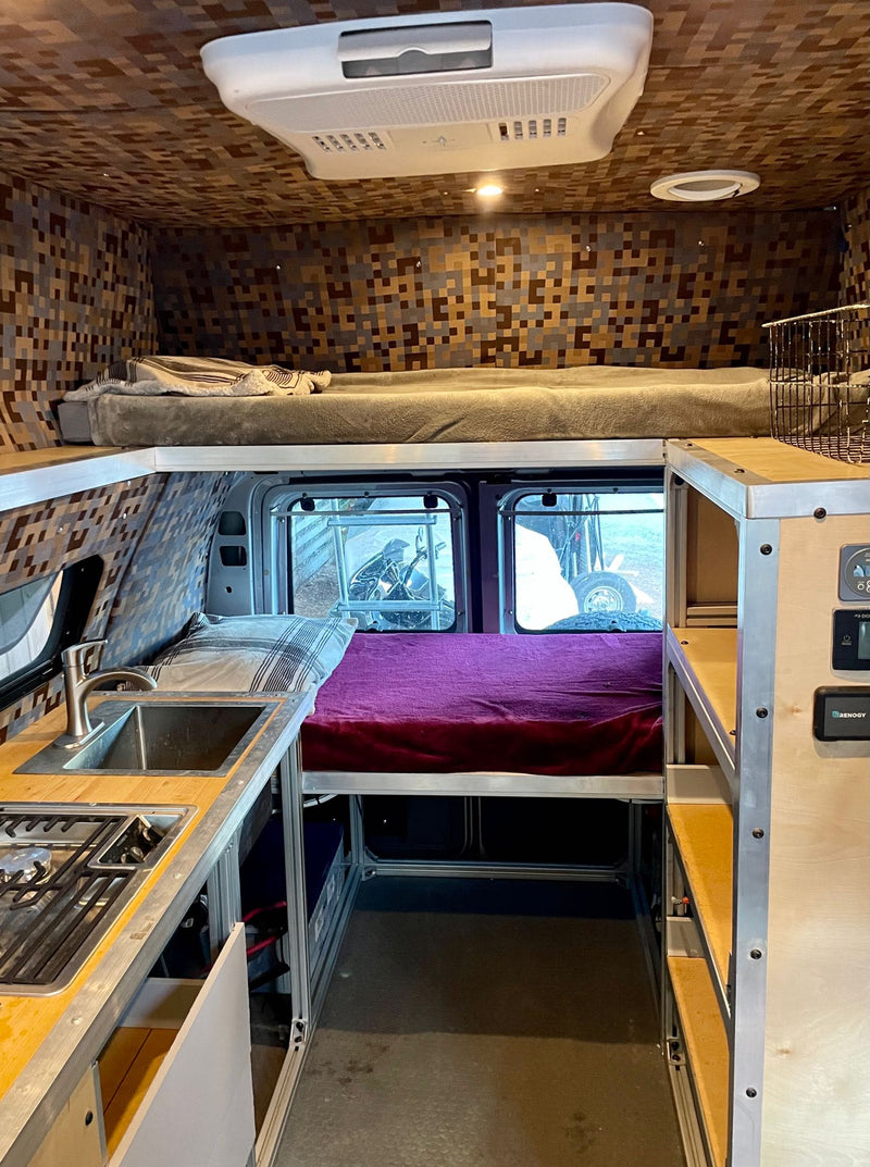  with seating and a small table on the lower level.|RV rental van interior: functional kitchen — photo 7