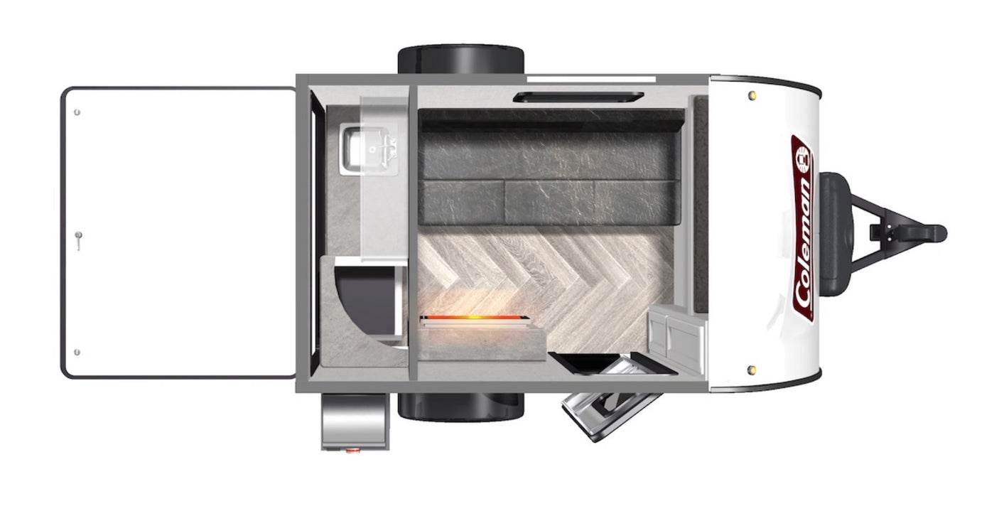 Overhead view of a Coleman rv rental travel trailer interior: bed, sink, and heating element on herringbone floor.