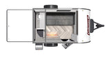 Overhead view of a Coleman rv rental travel trailer interior: bed, sink, and heating element on herringbone floor.